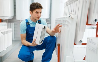 plumber-shows-heating-radiator-section-plumbering-2021-08-27-09-45-16-utc